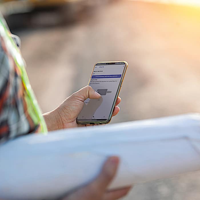 skyra app holding smartphone